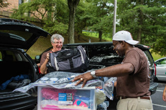 President John D. Simon and Henry Odi, vice provost for academic outreach and diversity, were among the many Lehigh volunteers who helped unload student cars.