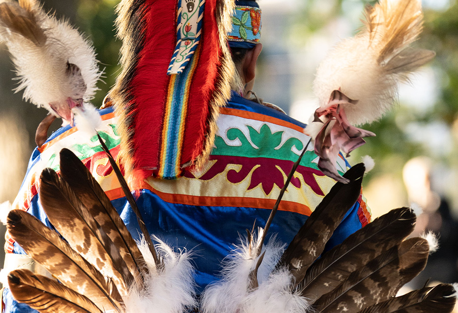 Native American wearing traditional feathers