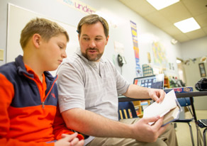 Teacher assisting student