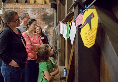 People looking at a paper banner