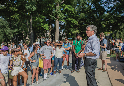 President John Simon talking to students on campus