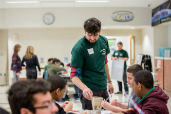 Graduate student assists middle schoolers at Lehigh University's annual BioFair.
