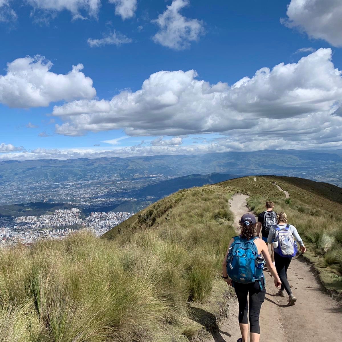 Three people hiking on a path