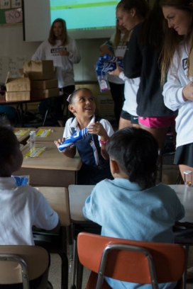 McKinley Elementary student receives an umbrella from a Lehigh scholar athlete.