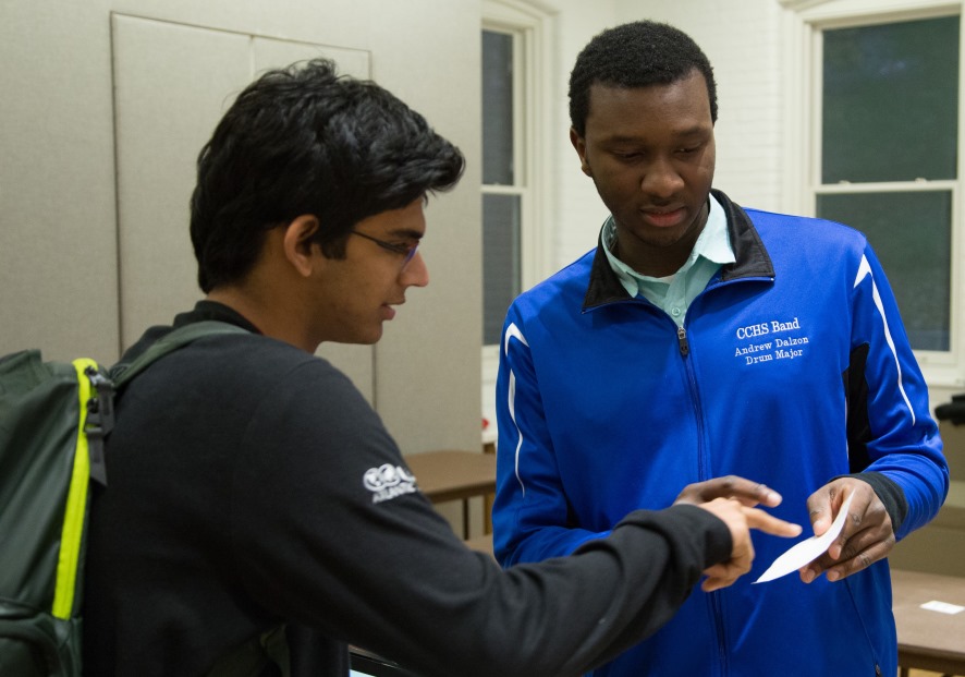 Andrew Dalzon ’19, a CSB major, shows a visitor how StockVise works