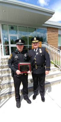Officer Drew Devery, left, was presented with the LUPD Officer of the Year Award by Chief Ed Shupp.
