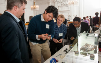 Guests look at student projects in computer science and engineering.