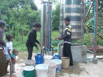 Children in Cambodia operate an arsenic-removal system that was installed by the Tagore-SenGupta Foundation.