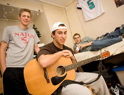 Three male students in a residence hall