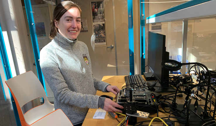 Kelly Zona, manager of Wilbur Powerhouse Design Labs, shows a device in the Electronics Design Studio.