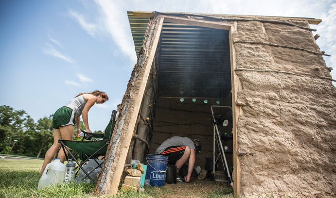 Students build a cooking hut in order to test levels of black carbon air pollution.